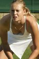 Maria Sharapova at Wimbledon 2004, ready to receive a serve, showing her boobs in a deep cleavage